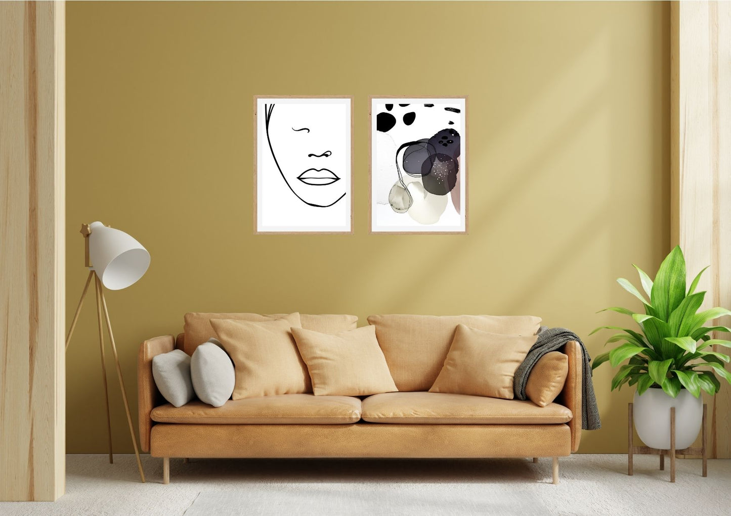 Minimalist Line Art Face and Abstract Expressionist Print Set (2 framed pieces) over a gold sofa. Perfect modern living room wall decor and contemporary art trends.