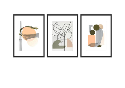 A triptych of three matching abstract geometric artworks. Each piece features a balanced composition of thin, fluid, black lines and geometric elements, contrasting with solid, flat shapes in a palette of olive green, dusty peach, and blush pink. The elements overlap to create depth. Wall art frames by wall and more