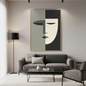 Modern minimalist cubist tableau of a geometric face in sage green, cream, and charcoal. This large-scale abstract portrait is framed in light wood and mounted in a contemporary grey living room above a charcoal sofa and coffee table in an Egyptian home.