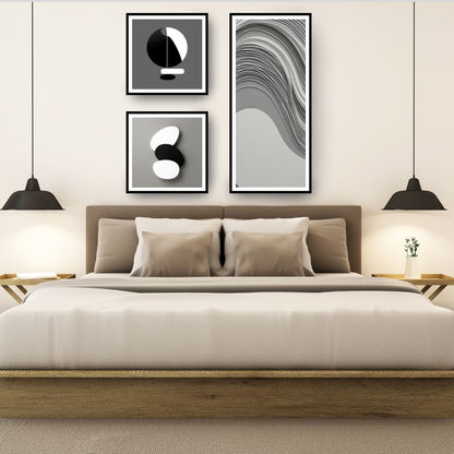 Monochromatic Abstract Art Set (3 framed prints) featuring minimalist black, white, and gray geometric shapes, including a long panel with Wavy Lines and two square panels with stacked forms. Ideal Modern Bedroom Decor.