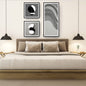 Monochromatic Abstract Art Set (3 framed prints) featuring minimalist black, white, and gray geometric shapes, including a long panel with Wavy Lines and two square panels with stacked forms. Ideal Modern Bedroom Decor.