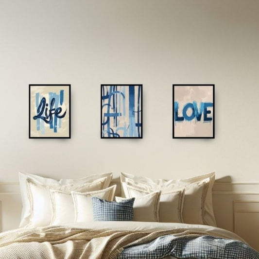 Three framed prints on a wall above a bed with 'Life' and 'Love' text.