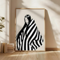 Large minimalist black and white figurative canvas wall art depicting a serene woman wrapped in graphic stripes, styled in a modern living room
